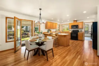 Kitchen with casual dining area with newly refinished hardwood floors and french door leading to the covered patio.