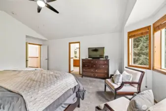 The primary bedroom features high ceilings and a peaceful atmosphere.