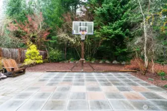 Pavered area off back of home, can double as additional outdoor living space or basketball court