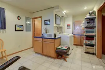 To the left is a full bath and there is a laundry space.  It would be perfect for a little kitchenette space for guests.