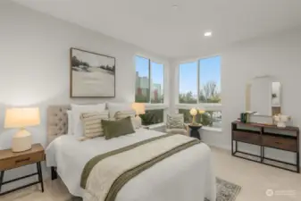 The primary bedroom is a serene retreat featuring vaulted ceilings, expansive windows, and private balcony access. Wake up to peaceful views and natural light flooding the space.