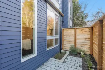 A private outdoor retreat framed by sleek fencing and minimalist landscaping—a perfect spot to unwind.