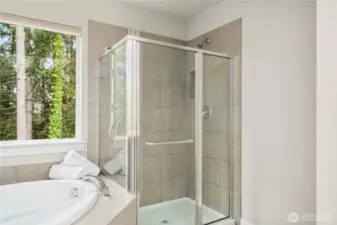 Standing glass shower is classy and chic in this bright and spacious en-suite