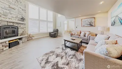As you enter, you're greeted by this large, welcoming, and brightly lit living/family room, with awesome views through the large windows.