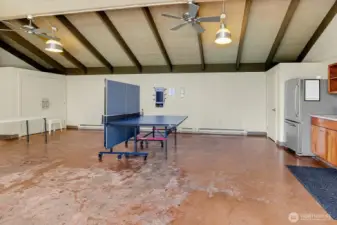 Rec room with games and kitchen next to pool to host summer gatherings