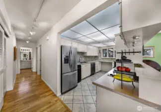 Plenty of storage throughout, hallway with additional closet leading to utility room, bedrooms and baths