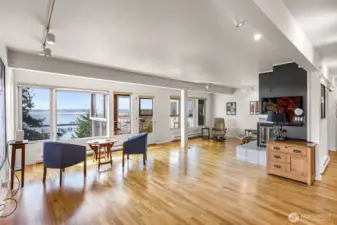 View from dining area into the main living, bright and open with water views from every angle