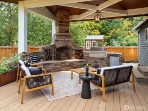 Covered outdoor dining with grill and fireplace