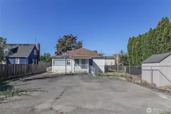 Parking pad in back of home holds many cars!  The shed also stays!