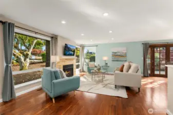 Floor-to-ceiling windows flood the living room with natural light.