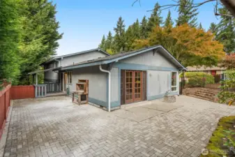 Expansive brick paver entertaining patio.