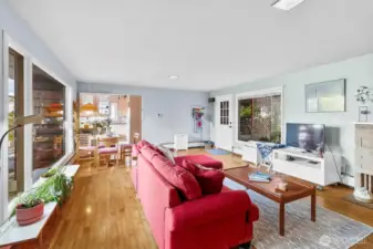 Open-concept living space showcases sightlines to dining and outdoor areas, creating easy flow throughout the main level.