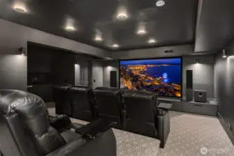 A theatre room with wet bar and refrigerator.