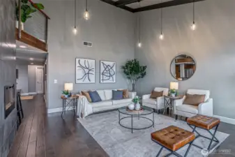 Seating area of the great room with suspended lighting.