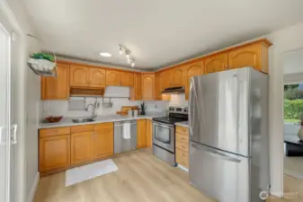 Efficient kitchen with room for a small island- quartz countertops and all stainless steel appliances.