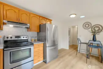 The kitchen leads to a utility room and the primary bedroom.