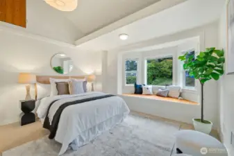 Lovely and lofted, the primary bedroom has such great light and spaces.