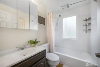 The full bath has ceramic tile surround new LVP floors, giant frosted window brings in great light!