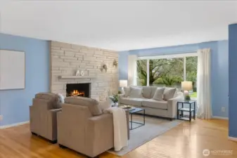 Open concept living to dining room space allows for easy entertaining while enjoying views from the large picture windows.