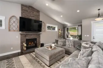 Cozy living room with stone fireplace and large sectional seating