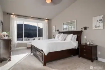 Primary bedroom with lake views and elegant wood furniture