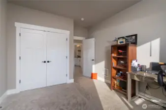 Bright flex room with office setup and spacious closet storage
