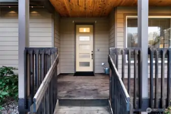 Inviting entry with covered porch and modern front door