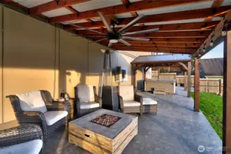 Covered patio with seating, fire pit, and outdoor living space