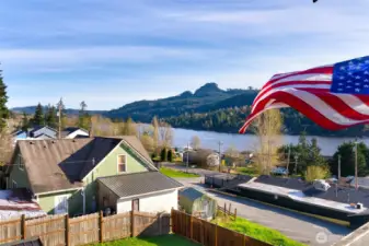 Scenic lake and mountain views with American flag on deck
