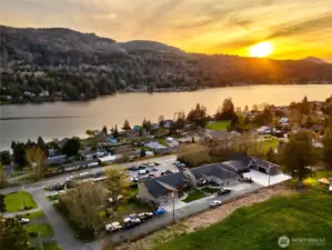 Stunning aerial lake view with sunset and scenic mountain backdrop