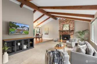 Sky High Ceilings with Beams, Masonry Fireplace, Wall Of Window Lets the Morning Sunshine In!  BIG Screen TV will stay if Buyer Would Like.