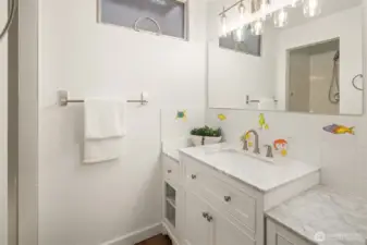 Sweet bathroom with marble counters and shower.