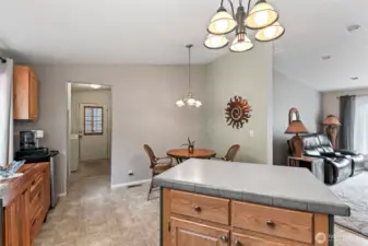 Cozy dining space near the side entry with neutral tones and charming wall decor.
