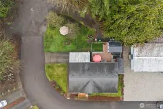 Drone perspective showing the home's thoughtful positioning and lush surroundings.