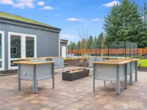 Relax under the stars around the modern firepit lounge—an ideal spot for evening chats and community connections.