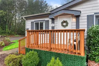 A fresh, NEW front porch welcomes you home with curb appeal galore, enhanced by mature shrubs and decorative touches.