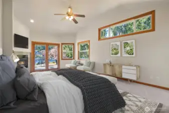 Main Level large primary bedroom with gas fireplace, seating area, French doors to deck, dock and yard. Fresh Paint & Carpets through-out!