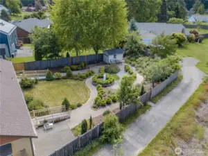 Enormous back yard gardens offer safe strolls amidst dozens of blooming roses and blooming fruit trees.