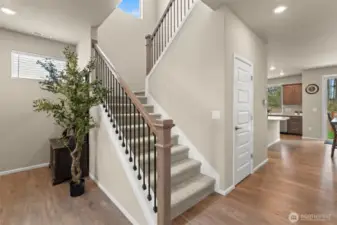 Warm and welcoming entryway with beautiful wood floors and a modern staircase—setting the tone for the rest of this thoughtfully designed home.
