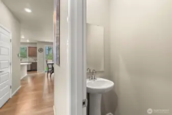 Convenient main-level powder room with a sleek pedestal sink—perfectly tucked away for guest use without sacrificing style or privacy