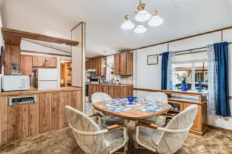 Bright dining area with vaulted ceilings is perfect for everyday meals or entertaining.