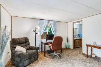 Primary suite offers extra space for seating, desk, or flexible use.