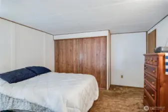 Another view of the secondary bedroom highlighting the spacious closet and layout.