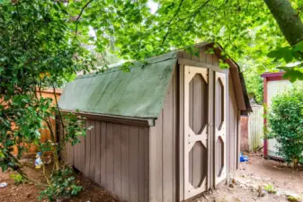 Detached storage shed with shelving provides space for tools, hobbies, or seasonal items.