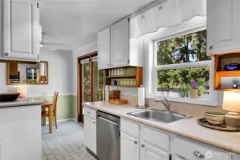 View from kitchen to dining area and double doors open to deck..