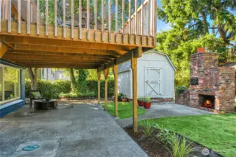 Patio under the deck.  Outdoor fireplace and oven.  Large, insulated, solid wood shed.