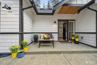 Three styles of exterior cement siding in warm bone tones outlined in deep charcoal plus handsome fixtures create a timeless retreat.  Enjoy nature or yard activites from the ample front raised aggregate patio porch.