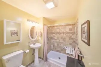 Bathroom has a walk-in shower with bench seat, widened doorway and lots of grab bars
