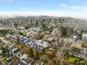 A bird’s-eye perspective of the well-planned community, featuring homes and nearby amenities framed by scenic surroundings.