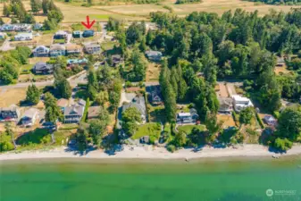 See home with quiet road to the right and in front of the home. There is a building site behind this home and two homes under construction to the right of of  red arrow and across Charel Drive but off of Semiahmoo Drive. You can see the cleared land in this picture.